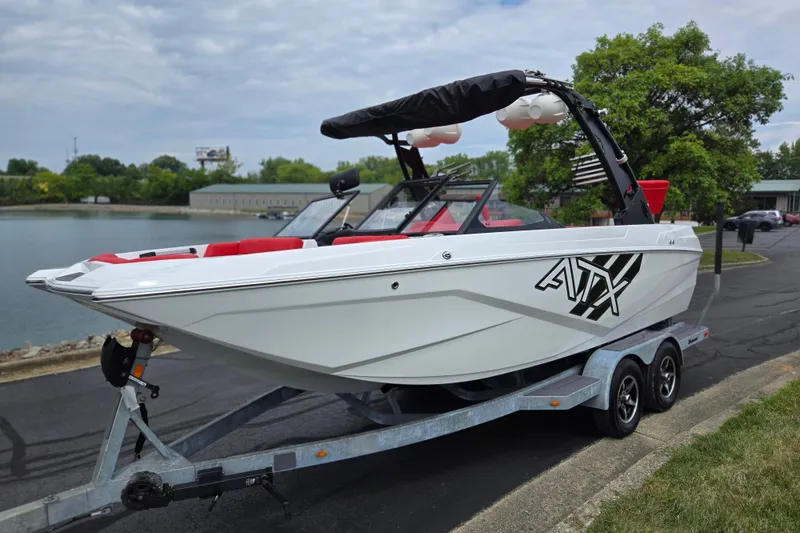 Slide: The Image of 2022 ATX Surf Boats 20 Type-S on trailer by a lake, featuring sleek design. - 9