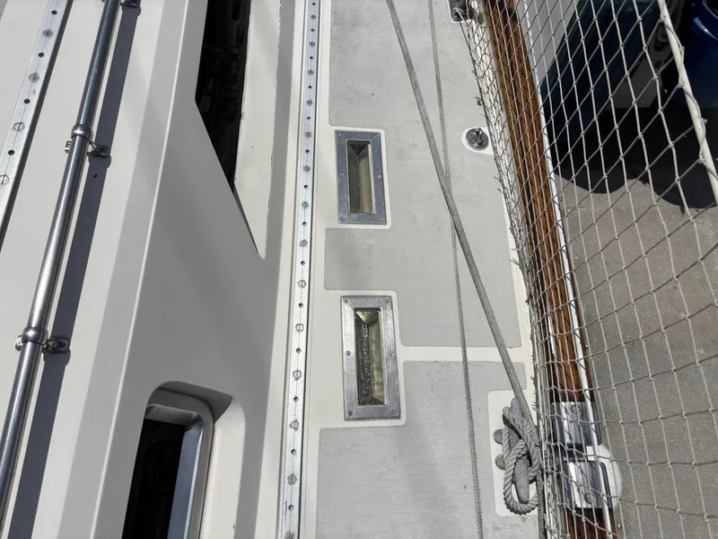 Slide: The Image of Deck of 1982 Norseman 447 sailboat with metal fixtures and safety netting. - 11