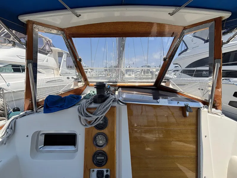 Slide: The Image of Cockpit view of 1982 Norseman 447 sailboat, featuring wooden paneling and nautical equipment. - 18