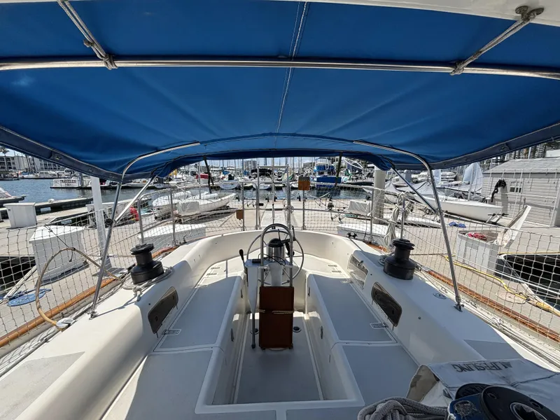 Slide: The Image of Cockpit view of 1982 Norseman 447 sailboat with blue canopy at marina. - 19