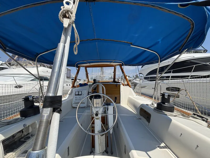 Slide: The Image of Cockpit of 1982 Norseman 447 sailboat with blue canopy and steering wheel. - 20