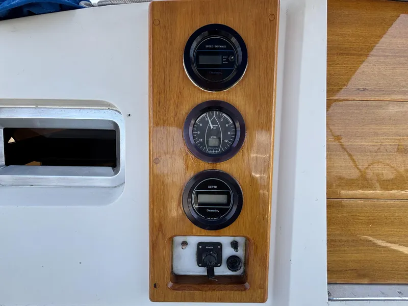 Slide: The Image of Wooden dashboard with speed, distance, and depth gauges on a 1982 Norseman 447 boat. - 26
