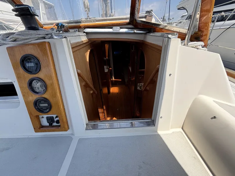 Slide: The Image of Cockpit view of 1982 Norseman 447 sailboat, showing cabin entrance and wooden interior. - 28