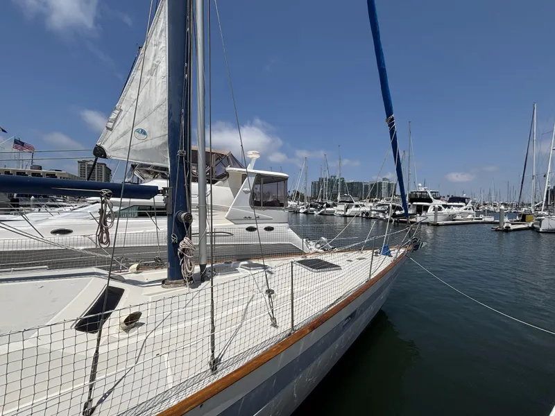 Slide: The Image of Sailboat Norseman 447, 1982 model, docked in a marina under clear blue skies. - 3