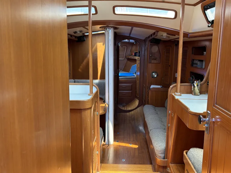 Slide: The Image of Interior of 1982 Norseman 447 sailboat with wooden furnishings and cozy seating. - 30