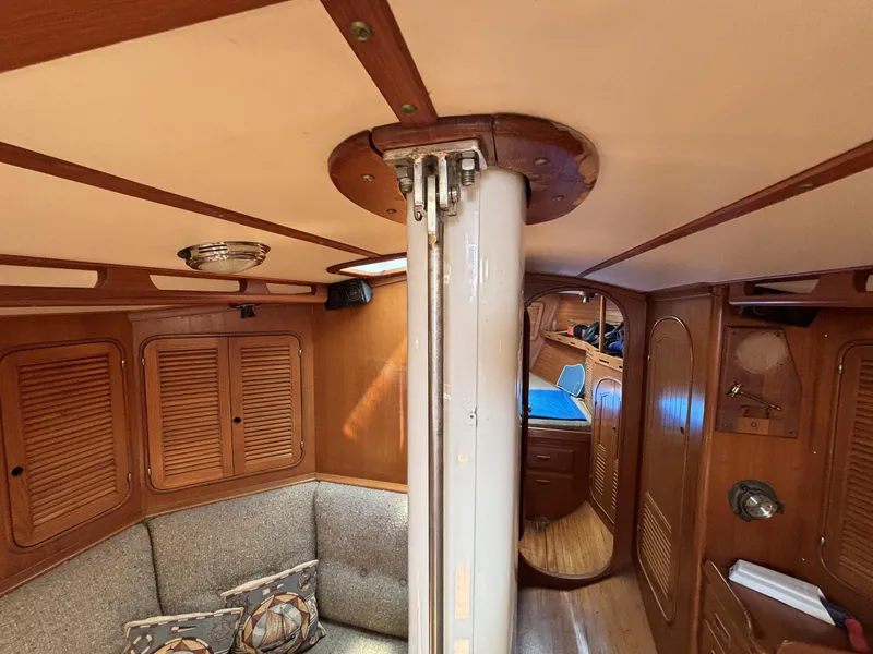Slide: The Image of Interior of 1982 Norseman 447 sailboat with wooden paneling and cozy seating area. - 32