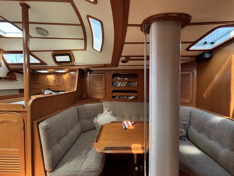 Slide: The Image of Cozy interior of 1982 Norseman 447 sailboat with wooden finishes and cushioned seating. - 33