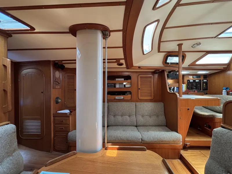 Slide: The Image of Interior of 1982 Norseman 447 sailboat with wooden furnishings and cozy seating. - 35