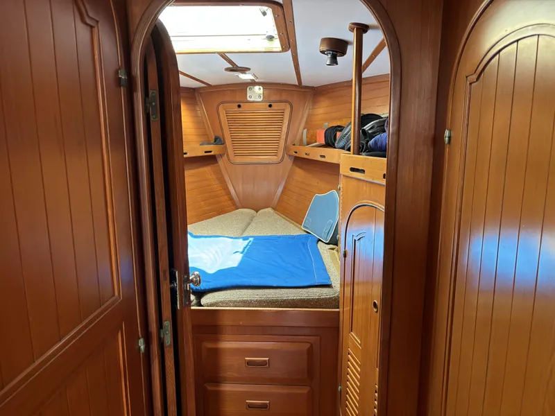 Slide: The Image of Cozy wooden cabin interior of 1982 Norseman 447 sailboat with bed and storage. - 36