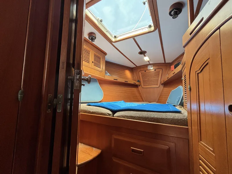 Slide: The Image of Cozy cabin interior of 1982 Norseman 447 sailboat with wooden finish and skylight. - 37