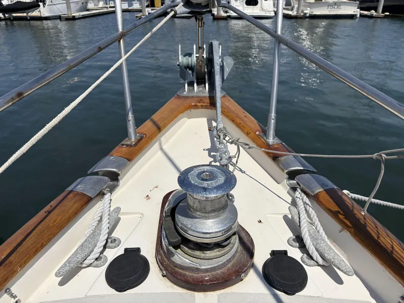 Slide: The Image of Bow of 1982 Norseman 447 sailboat with winch and ropes in marina. - 4