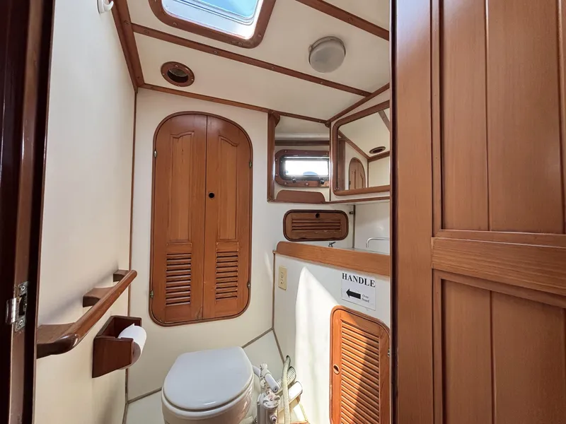 Slide: The Image of 1982 Norseman 447 yacht bathroom with wooden cabinetry and skylight. - 44
