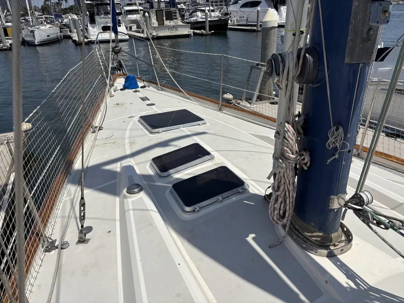 Slide: The Image of Deck of 1982 Norseman 447 sailboat in marina, featuring hatches and rigging. - 5