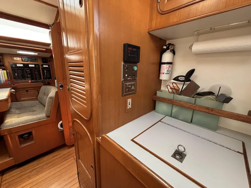 Slide: The Image of Interior of 1982 Norseman 447 yacht with wooden cabinetry and seating area. - 51