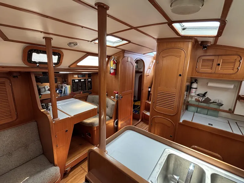 Slide: The Image of Interior of 1982 Norseman 447 sailboat, featuring wood paneling and compact living space. - 52