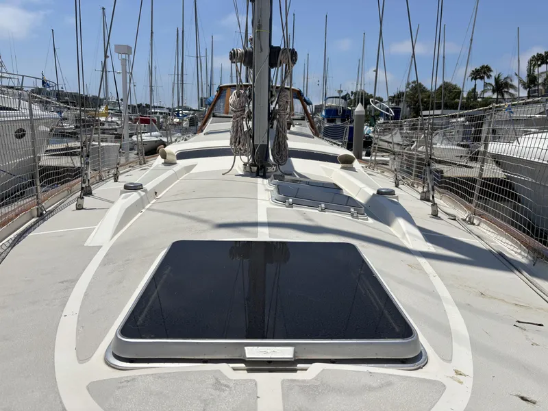 Slide: The Image of Sailboat deck view, Norseman 447, 1982 model, docked in marina with clear sky. - 6