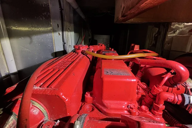 Slide: The Image of Red engine of a 1982 Norseman 447, showcasing intricate mechanical components. - 69