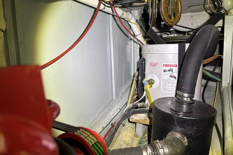 Slide: The Image of Engine compartment of a 1982 Norseman 447 with hoses and warning labels. - 71