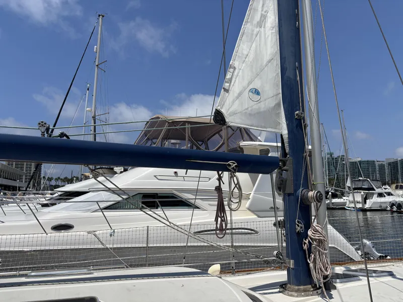 Slide: The Image of Sailboat Norseman 447, 1982 model, docked in marina with clear blue sky. - 9