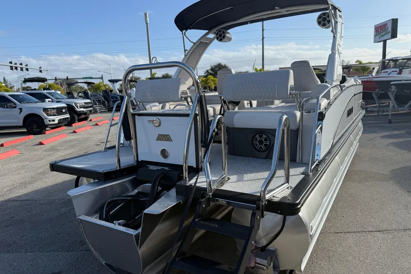 Slide: The Image of 2026 Avalon 2385 Catalina Quad Lounger Tri Toon boat, rear view in a parking lot. - 10