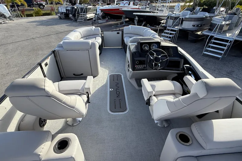 Slide: The Image of 2026 Avalon 2385 Catalina Quad Lounger, Tri Toon boat interior with luxurious seating and helm. - 17