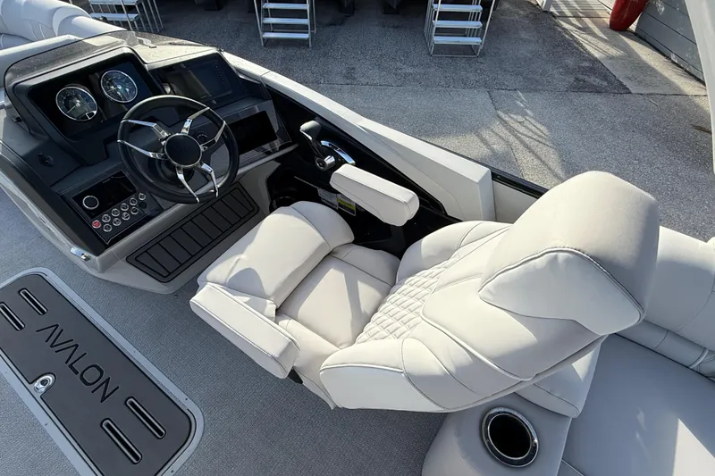 Slide: The Image of Luxurious helm of 2026 Avalon 2385 Catalina Quad Lounger, featuring plush seating and modern controls. - 27