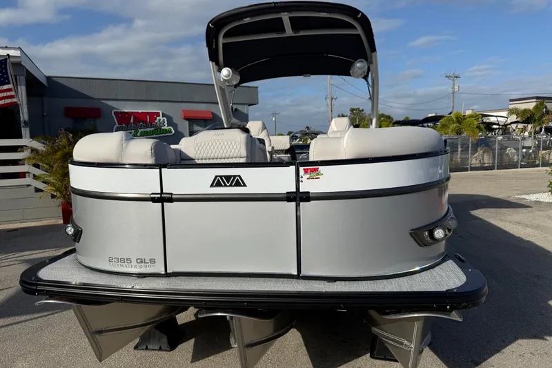 Slide: The Image of 2026 Avalon 2385 Catalina Quad Lounger Tri Toon boat, silver exterior, parked outdoors. - 5