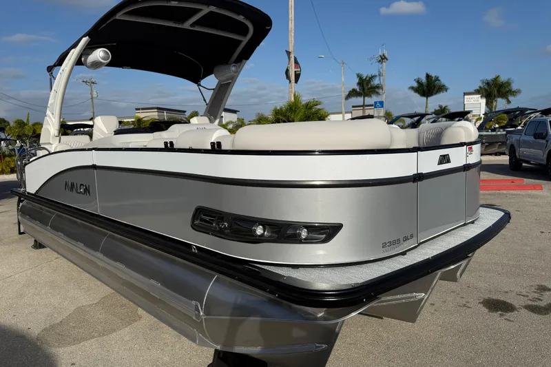 Slide: The Image of 2026 Avalon 2385 Catalina Quad Lounger, Tri Toon High Performance boat in a sunny outdoor setting. - 7
