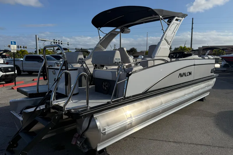 Slide: The Image of 2026 Avalon 2385 Catalina Quad Lounger Tri Toon boat in parking lot. - 8