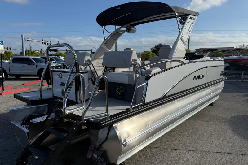 Slide: The Image of 2026 Avalon 2385 Catalina Quad Lounger Tri Toon boat in parking lot, side view. - 9