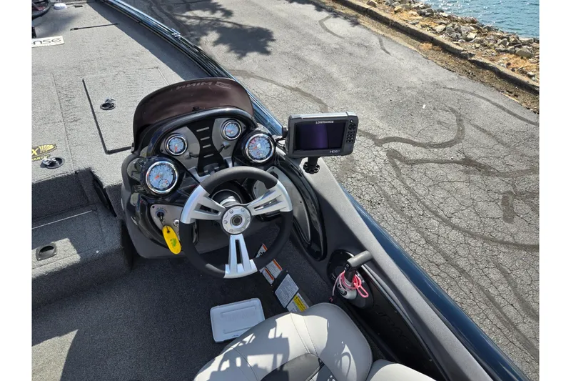 Slide: The Image of 2018 Tracker Pro Team 195 TXW boat dashboard with steering wheel and navigation system. - 12