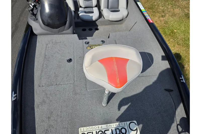 Slide: The Image of 2018 Tracker Pro Team 195 TXW boat interior with gray and red seating, carpeted deck. - 17