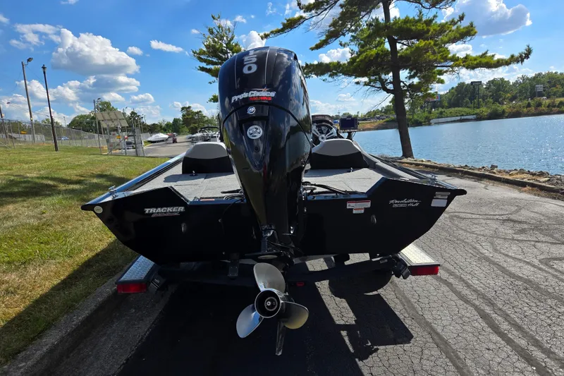 Slide: The Image of 2018 Tracker Pro Team 195 TXW 40th Anniversary Edition boat by a lakeside. - 2