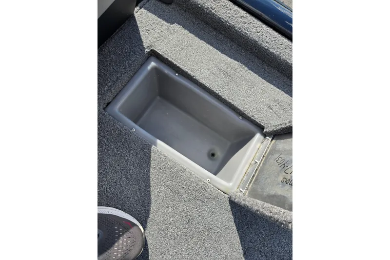 Slide: The Image of Open storage compartment in 2018 Tracker Pro Team 195 TXW boat, carpeted interior. - 21