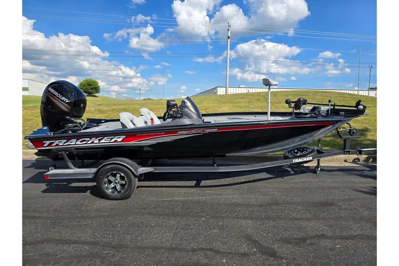 Slide: The Image of 2018 Tracker Pro Team 195 TXW 40th Anniversary Edition boat on trailer, under blue sky. - 4