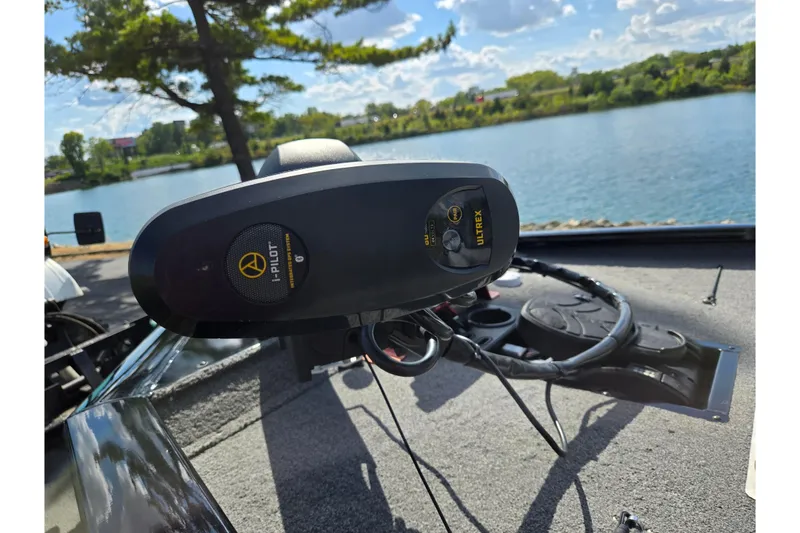 Slide: The Image of 2018 Tracker Pro Team 195 TXW boat with i-Pilot Ultrex motor by a scenic lake. - 8