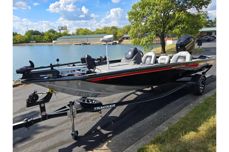 Slide: The Image of 2018 Tracker Pro Team 195 TXW 40th Anniversary Edition boat by a lake. - 9