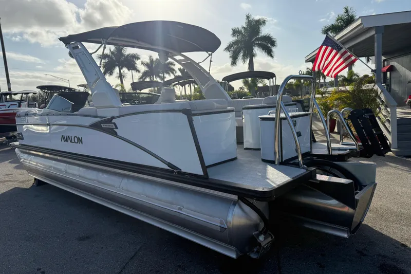 Slide: The Image of 2026 Avalon 2585 Catalina Windshield Quad Lounger with Mercury 400hp V-10 motor, docked under palm trees. - 10
