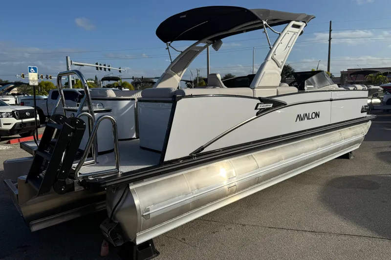 Slide: The Image of 2026 Avalon 2585 Catalina Windshield Quad Lounger with Mercury 400hp V-10 motor, parked outdoors. - 6