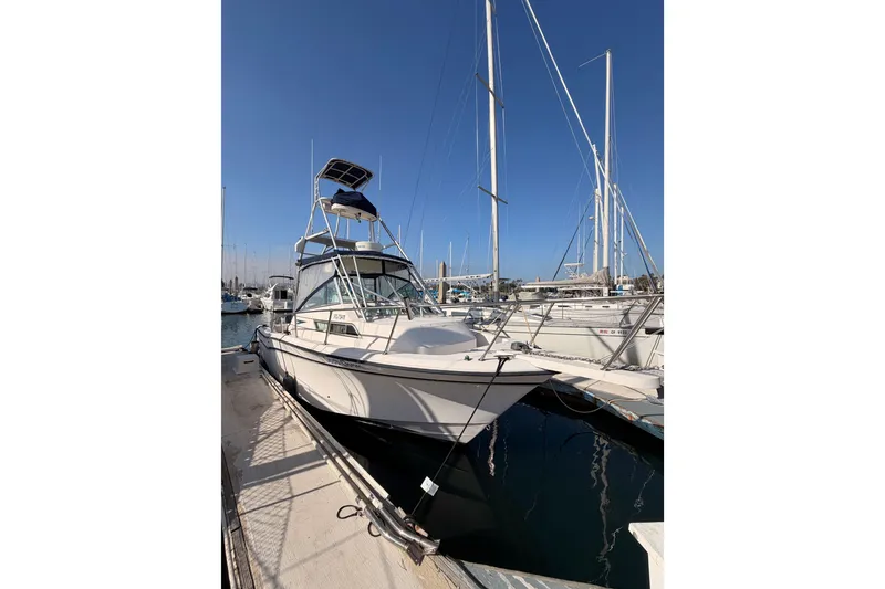 Slide: The Image of 1993 Grady-White Marlin 300 boat docked at marina under clear blue sky. - 1