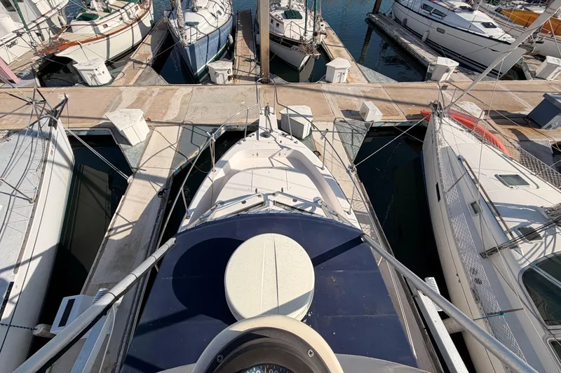 Slide: The Image of Overhead view of a 1993 Grady-White Marlin 300 docked among other boats. - 12