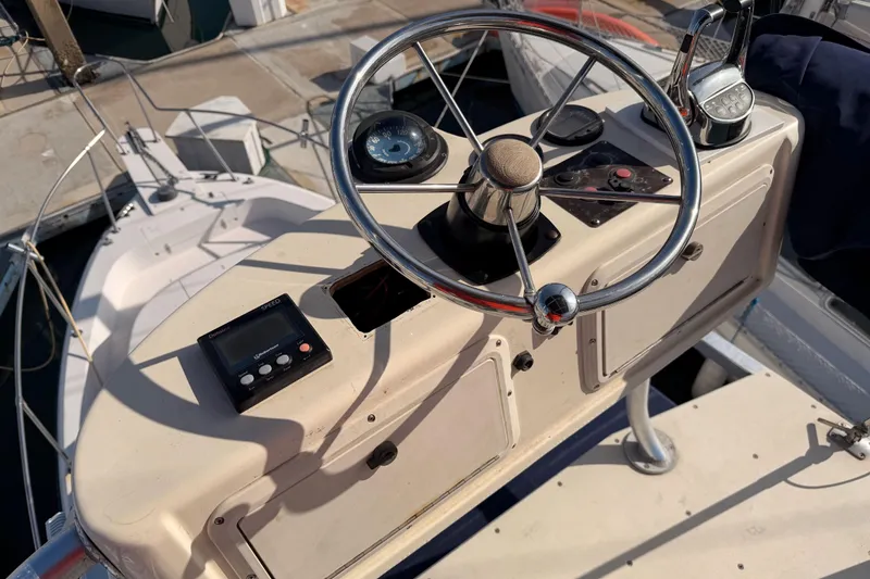 Slide: The Image of 1993 Grady-White Marlin 300 boat helm with steering wheel and controls. - 16