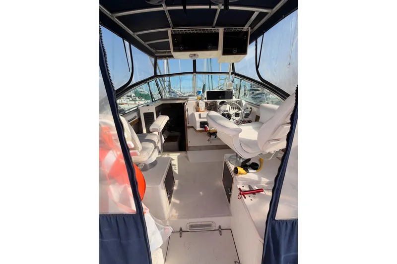 Slide: The Image of 1993 Grady-White Marlin 300 boat interior with helm, seats, and navigation equipment. - 17