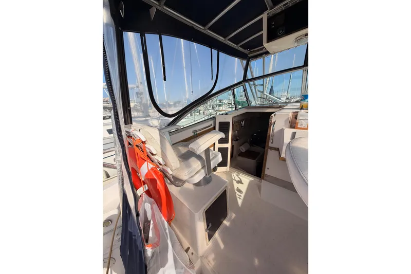 Slide: The Image of 1993 Grady-White Marlin 300 boat interior with helm, seating, and life preserver. - 19