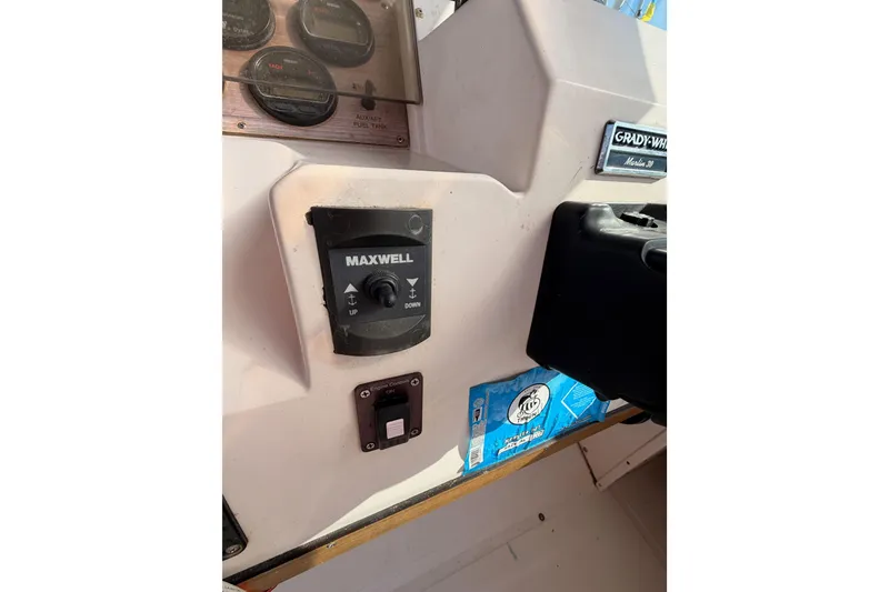 Slide: The Image of 1993 Grady-White Marlin 300 boat dashboard with Maxwell control panel and gauges. - 24