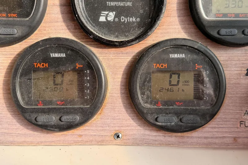 Slide: The Image of Yamaha tachometers on 1993 Grady-White Marlin 300 boat dashboard, displaying engine hours. - 25