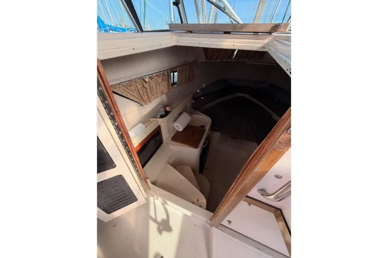 Slide: The Image of 1993 Grady-White Marlin 300 cabin interior with seating and storage. - 28