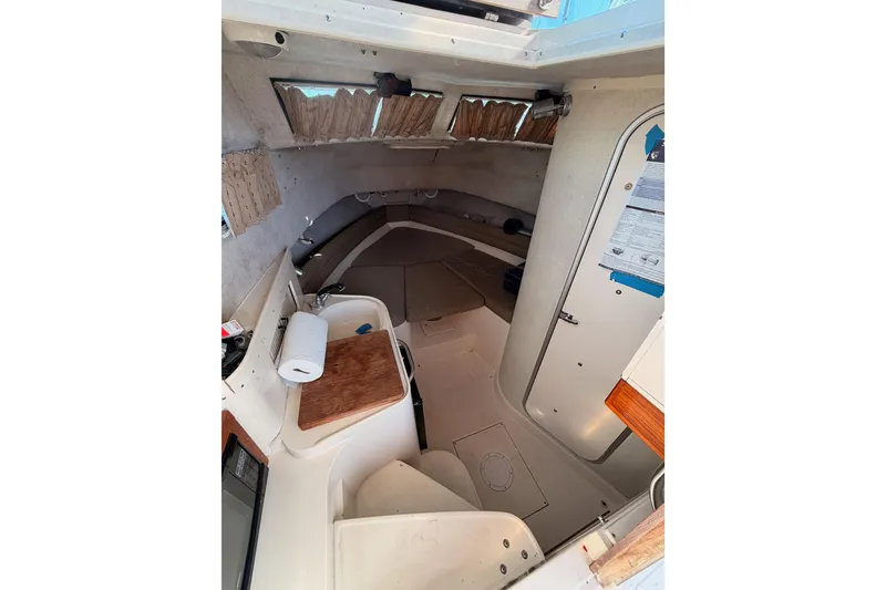 Slide: The Image of Interior of 1993 Grady-White Marlin 300 boat, featuring cabin amenities and seating. - 29
