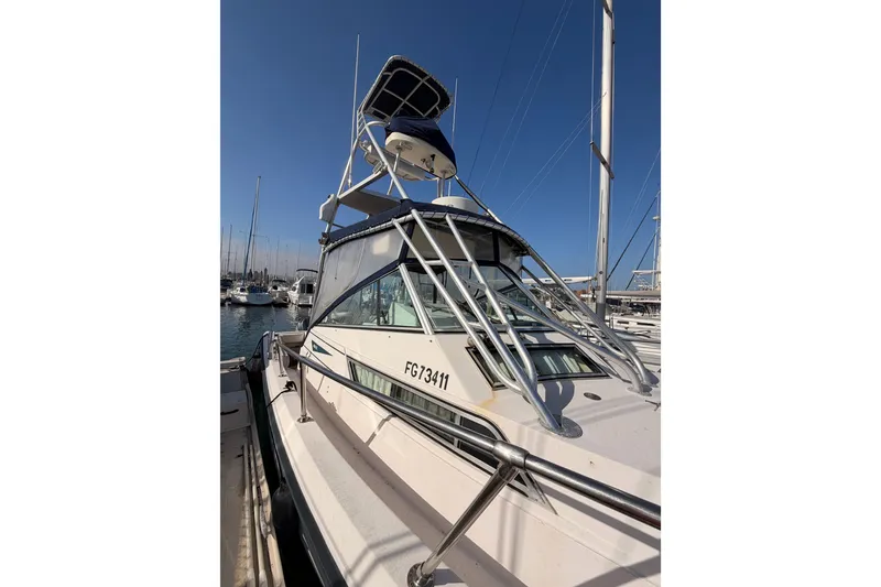 Slide: The Image of 1993 Grady-White Marlin 300 boat docked in marina under clear blue sky. - 3