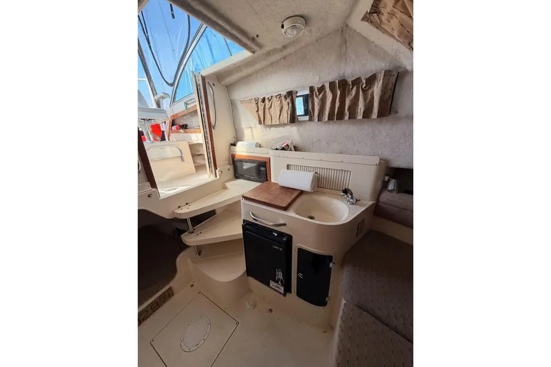 Slide: The Image of Interior of 1993 Grady-White Marlin 300 boat with kitchenette and seating area. - 31